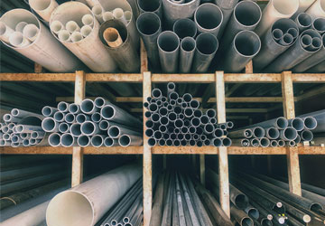 PVC and ABS plumbing pipes on a shelif in a plumbing supply warehouse