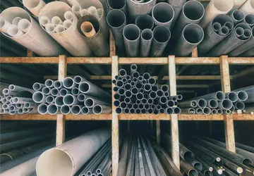 PVC and ABS plumbing pipes on a shelif in a plumbing supply warehouse